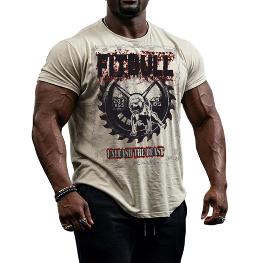A male bodybuilder wears a sands colored Fitbull  T-shirt with a motivational Unleash The Beast print