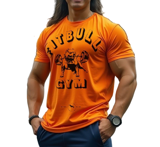 A man with a fitness body is wearing sporty joggers and a sporty orange Fitbull T-shirt with a motivating Fitbull Gym print.